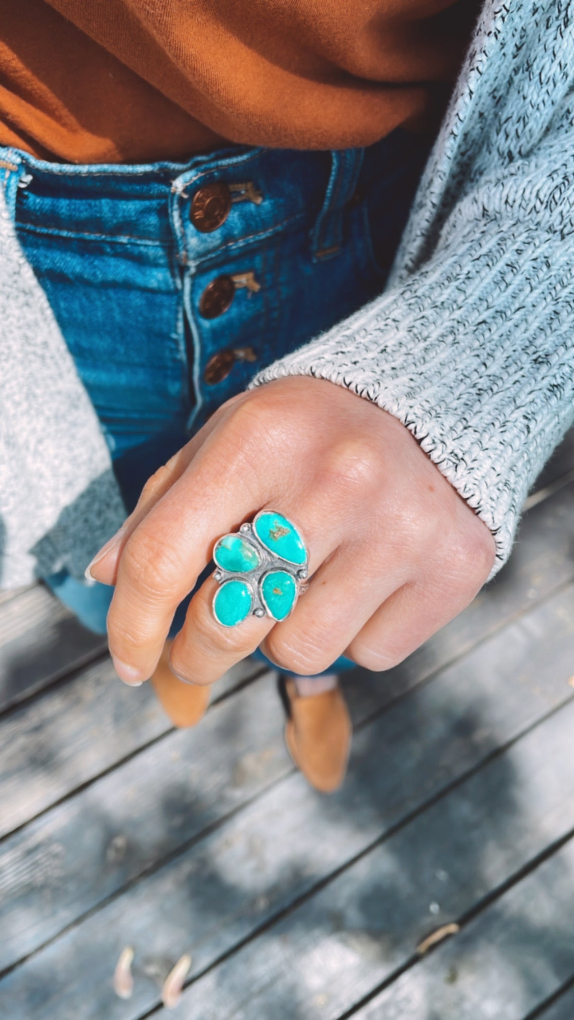 four stone turquoise ring worn by female with autumn hues