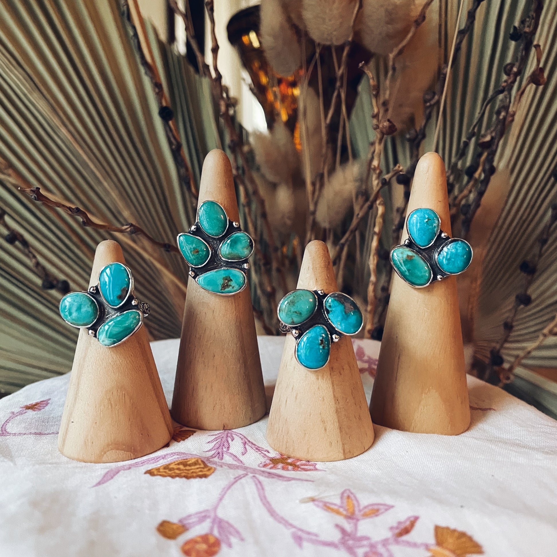 a collection of multi stone cluster turquoise rings