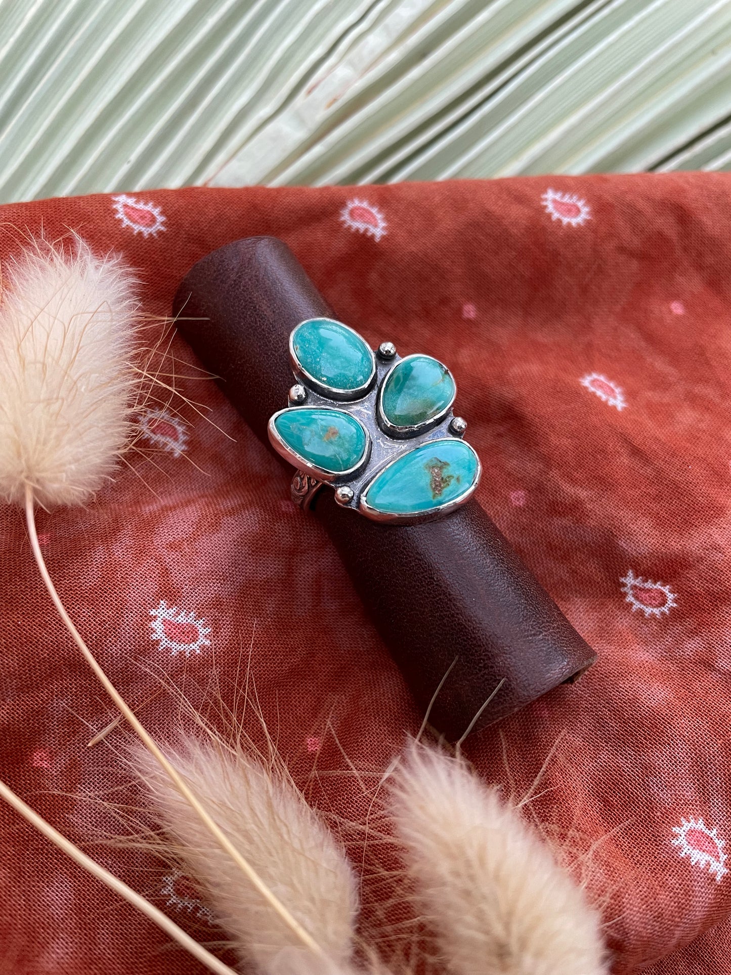 turquoise ring that features four stones in a cluster design.
